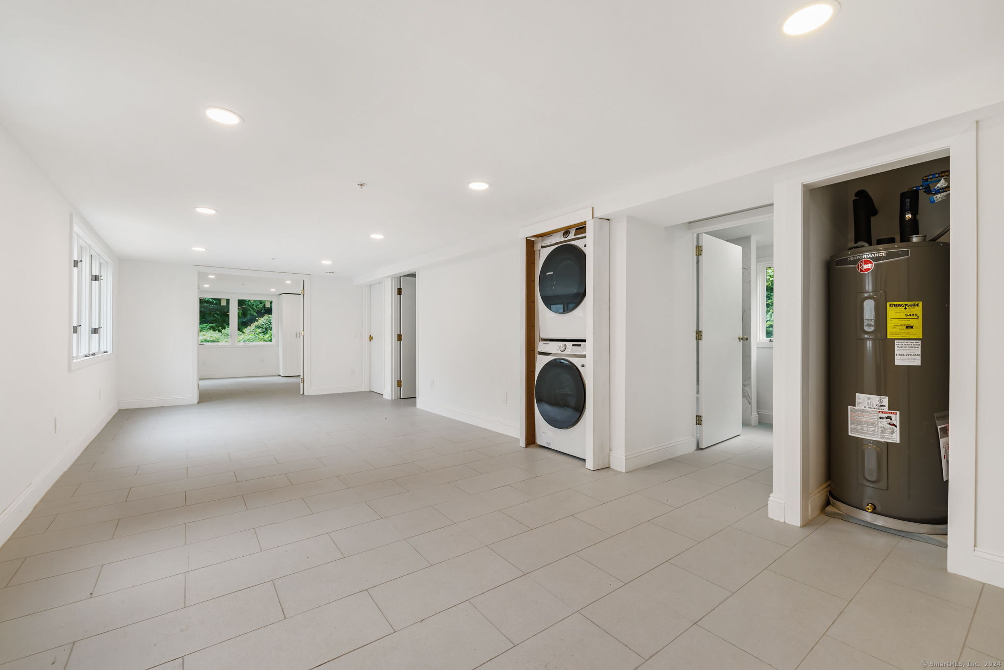 529 Danbury Road, Unit A Wilton, CT 06897 - Photo 18 of 23 a view of a livingroom with a fireplace and a chandelier