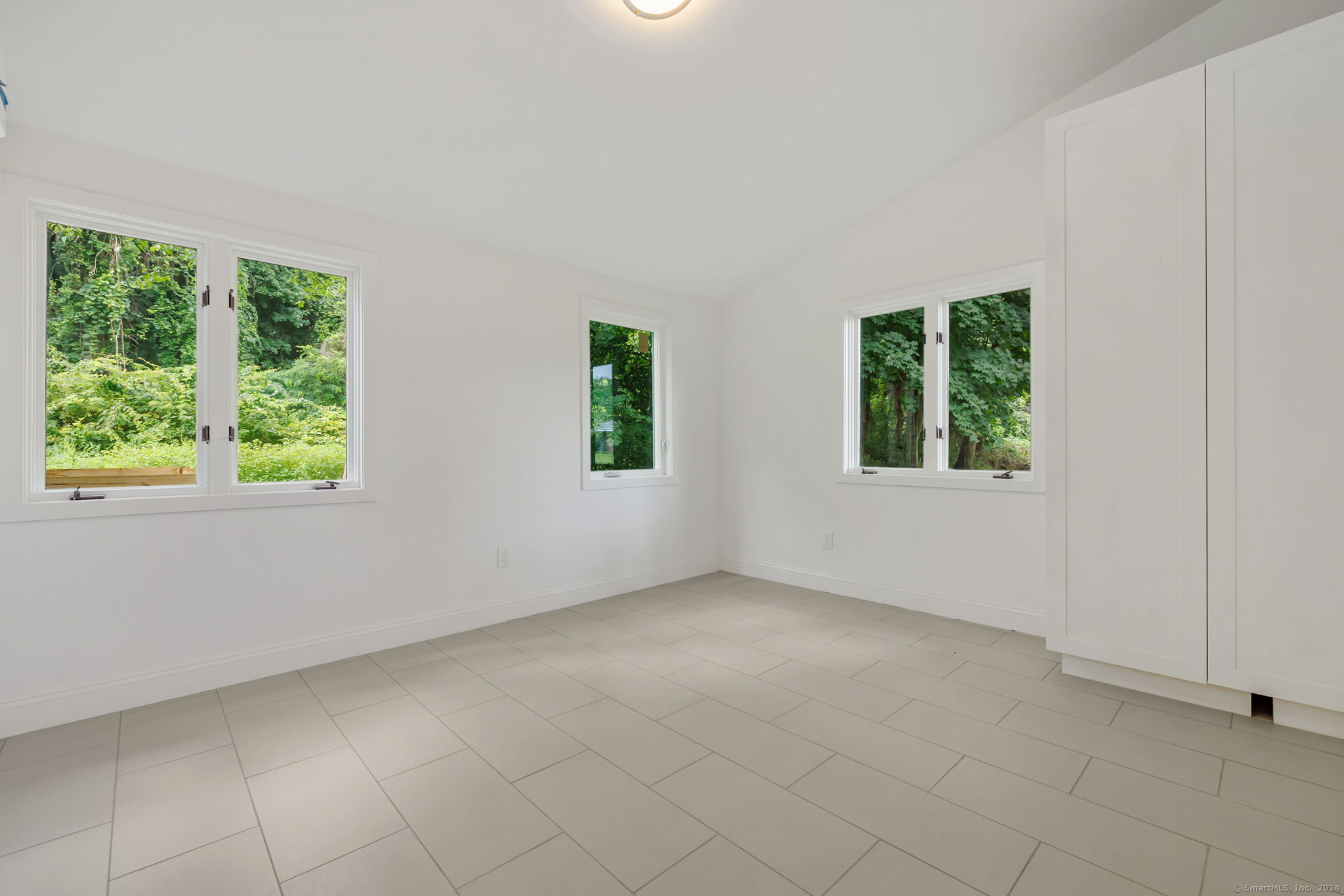 529 Danbury Road, Unit A Wilton, CT 06897 - Photo 19 of 23 an empty room with windows