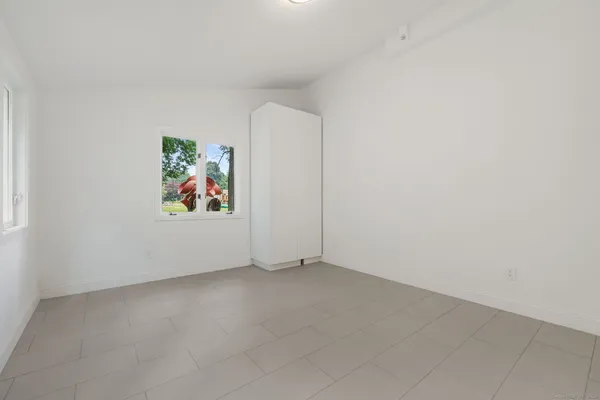 an empty room with painting on the wall