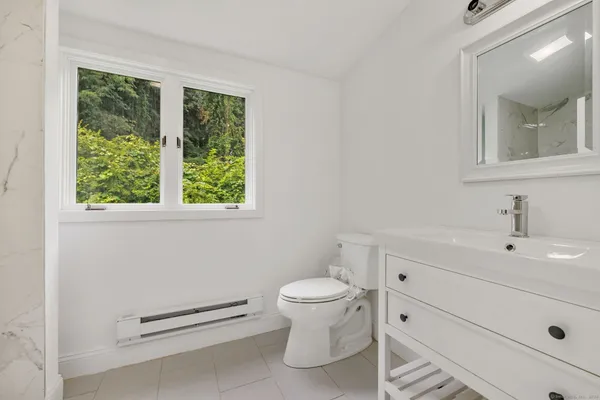 a bathroom with a toilet a sink and a mirror