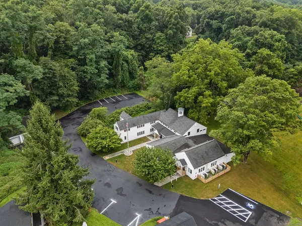 an aerial view of a house with a yard