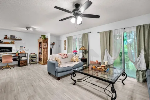 a living room with furniture and a floor to ceiling window