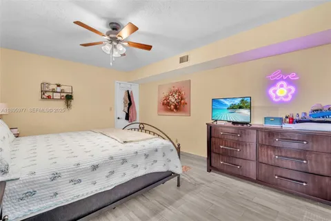 a bedroom with a bed and a mirror on dresser