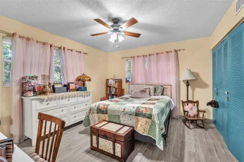 a bedroom with a bed a table and chair