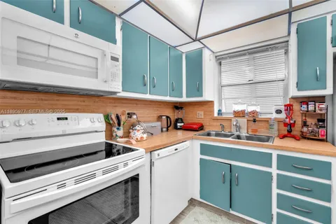 a view of a kitchen with appliances and cabinets