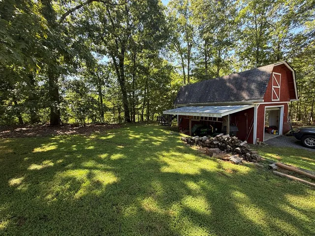 a view of a house with a yard garage and sitting area
