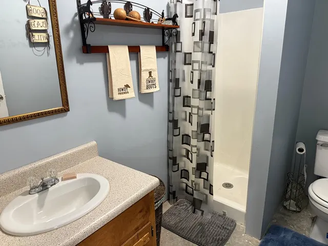 a bathroom with a sink toilet and shower