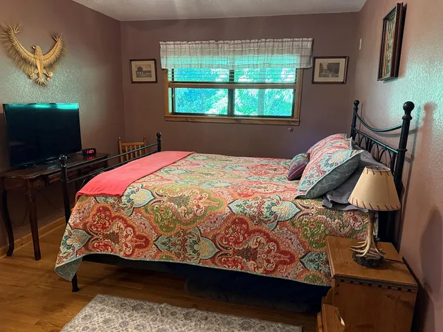 a bedroom with a bed and a chandelier