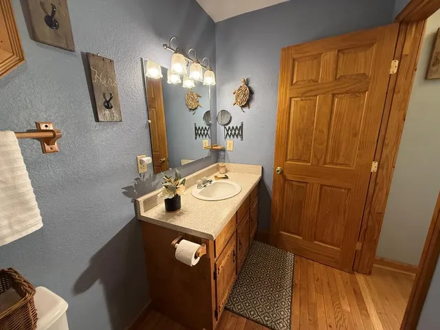 a bedroom with a bed and a dresser next to a window