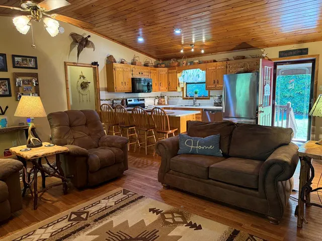 a living room with furniture and a chandelier