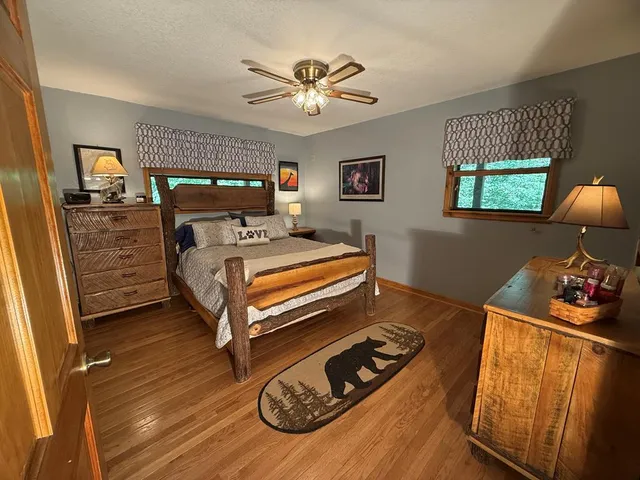 a bedroom with a bed and a chandelier