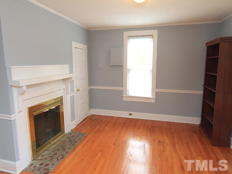 2216 Ellis Chapel Road Bahama, NC 27503 - Photo 4 of 13 a view of empty room with wooden floor and fireplace