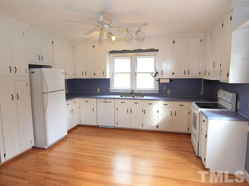 2216 Ellis Chapel Road Bahama, NC 27503 - Photo 7 of 13 a kitchen with granite countertop a sink cabinets and stainless steel appliances