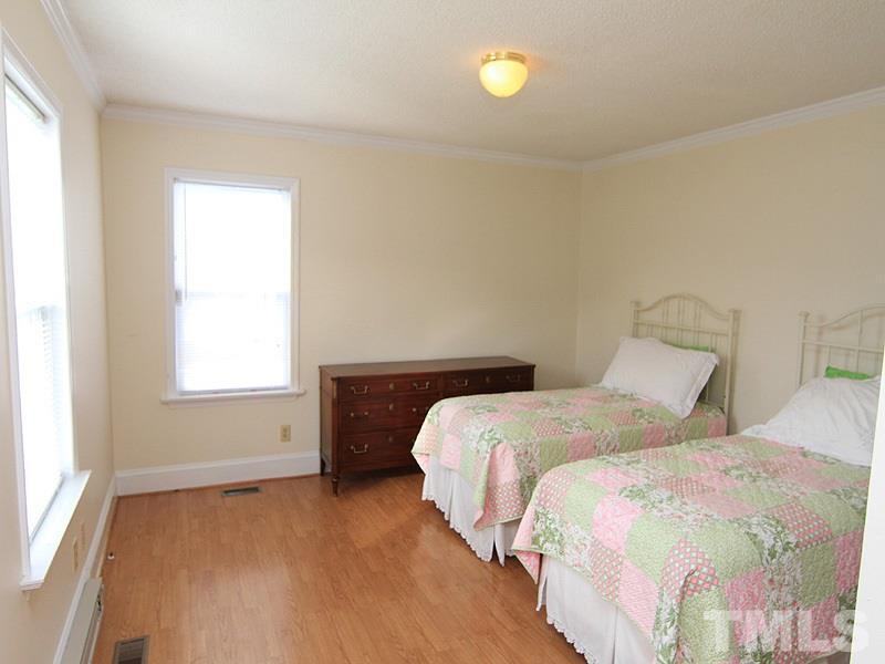 2216 Ellis Chapel Road Bahama, NC 27503 - Photo 9 of 13 a bedroom with two beds and a window