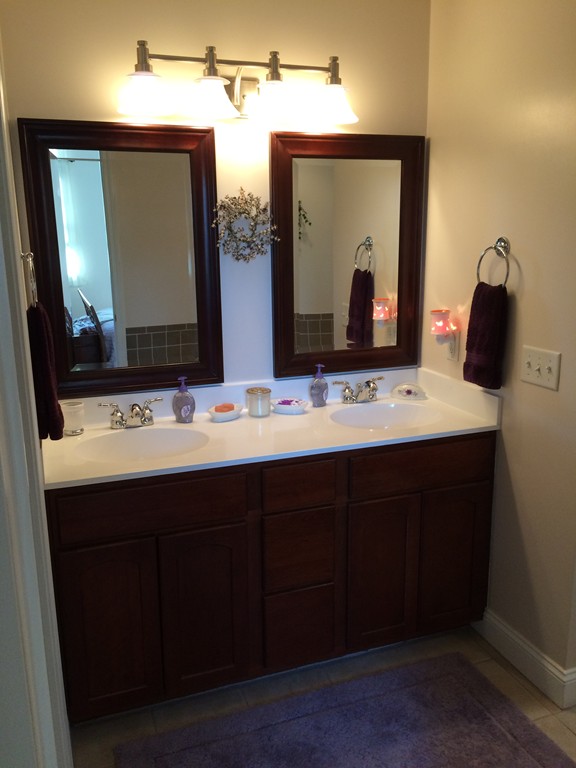 246 East County Road Rutland, MA 01543 - Photo 18 of 30 a bathroom with a double vanity sink and a mirror