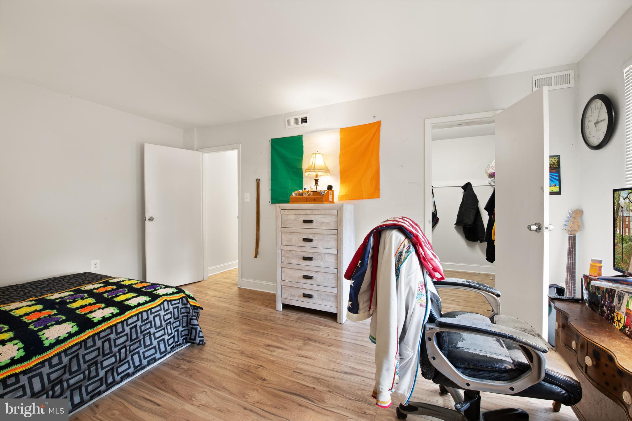 3914 Bel Pre Road, Unit 3914 Silver Spring, MD 20906 - Photo 12 of 16 a bedroom with a bed and a chandelier