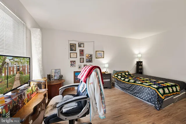 a bedroom with a bed and wooden floor