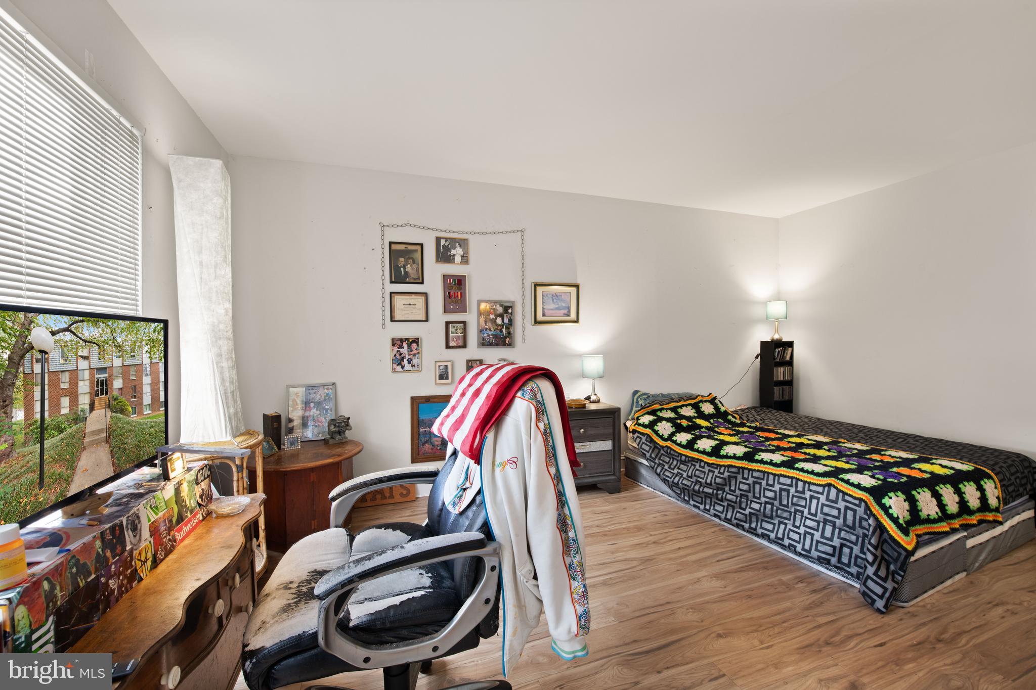 3914 Bel Pre Road, Unit 3914 Silver Spring, MD 20906 - Photo 14 of 16 a bedroom with a bed and wooden floor