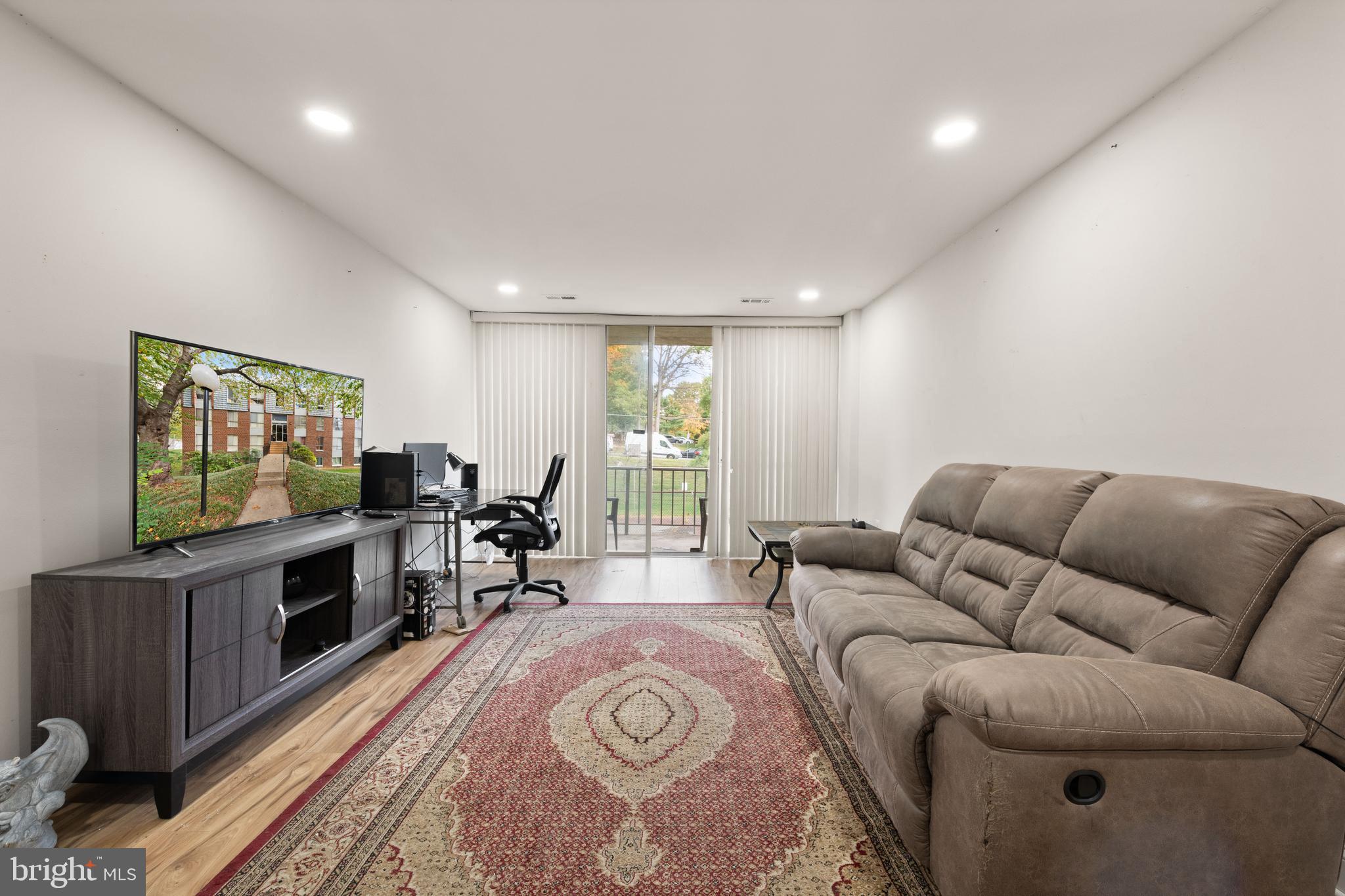 3914 Bel Pre Road, Unit 3914 Silver Spring, MD 20906 - Photo 2 of 16 a living room with furniture and a flat screen tv