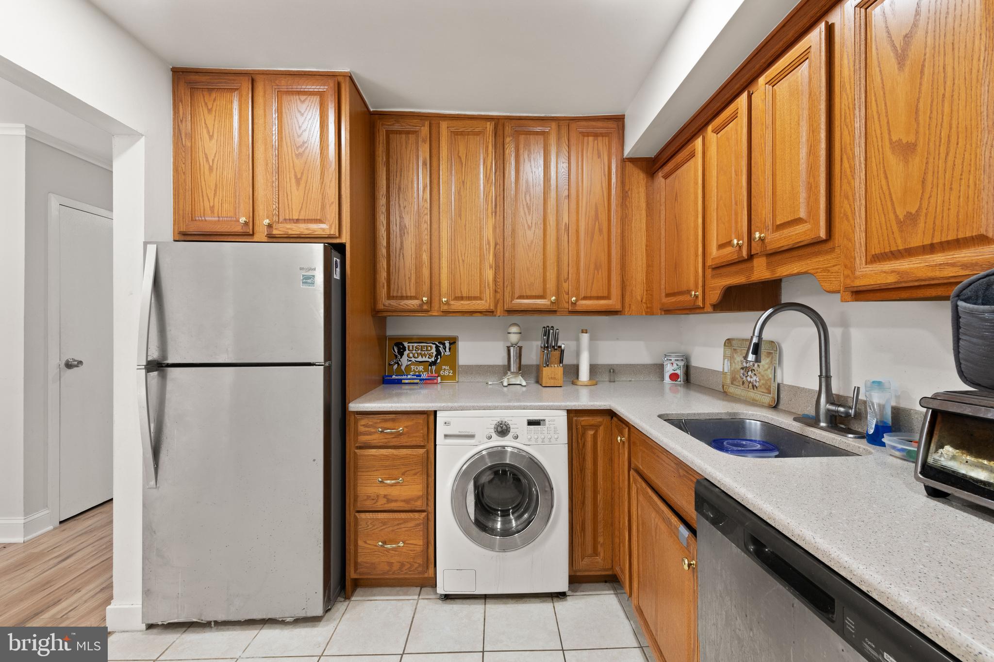 3914 Bel Pre Road, Unit 3914 Silver Spring, MD 20906 - Photo 6 of 16 a kitchen with a refrigerator sink and cabinets