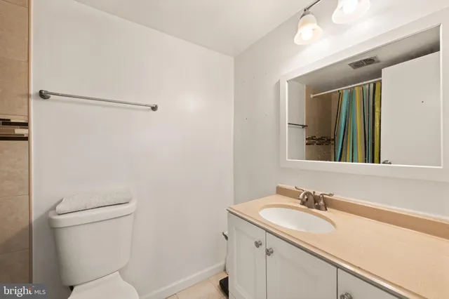 a bathroom with a sink toilet vanity and tub