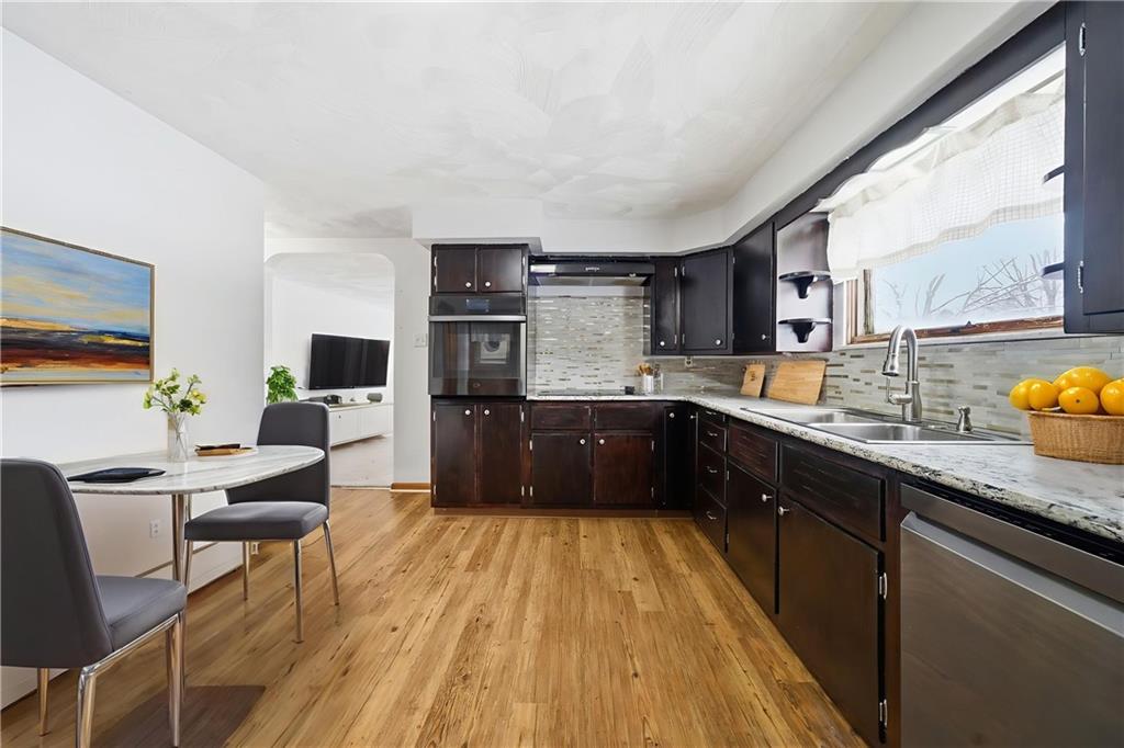 176 McMichael Road Pittsburgh, PA 15205 - Photo 8 of 32 a kitchen with stainless steel appliances granite countertop wooden cabinets a sink a stove and a refrigerator