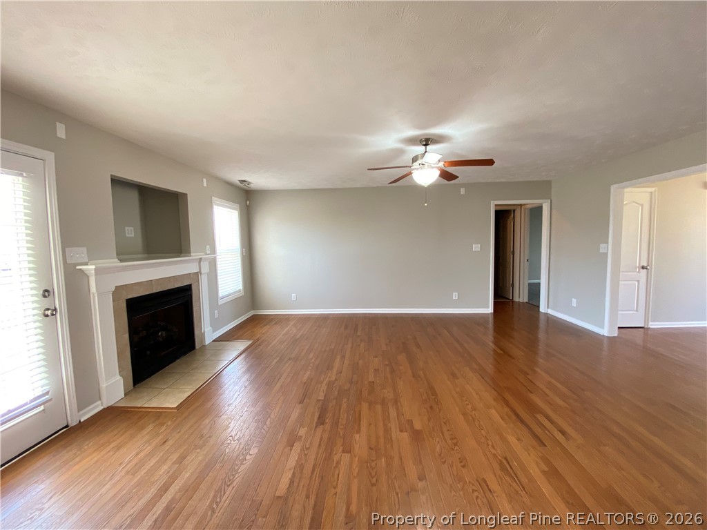 58 Polk Street Spring Lake, NC 28390 - Photo 10 of 26 a view of an empty room with wooden floor and a fireplace