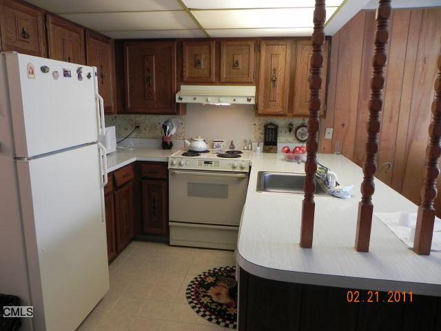 a kitchen with a refrigerator and a stove