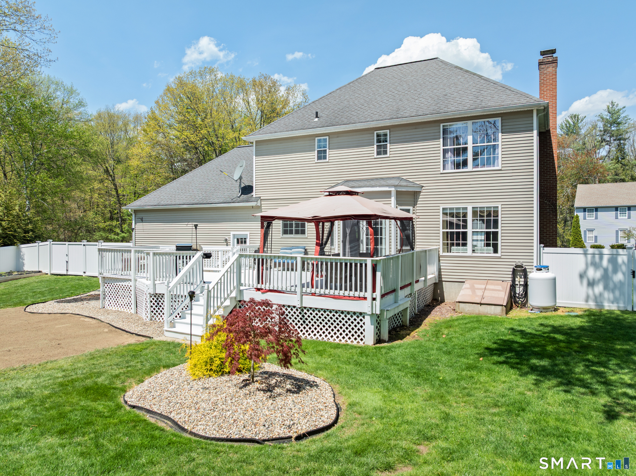 5 Ice Pond Road Granby, CT 06035 - Photo 34 of 40 a front view of a house with a yard table and chairs