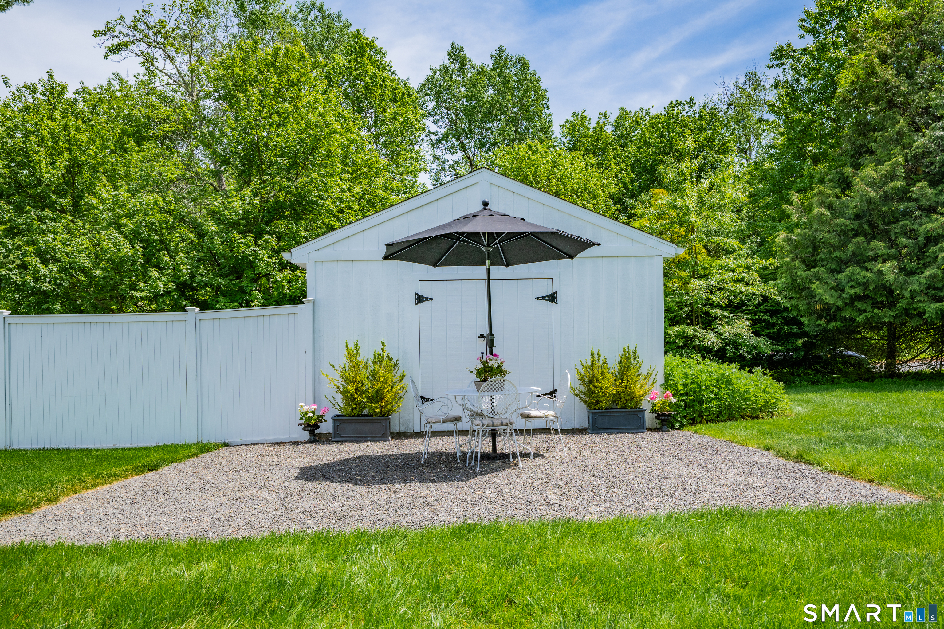 1000 Bassett Road Watertown, CT 06795 - Photo 27 of 35 a view of a wooden house with a yard and potted plants