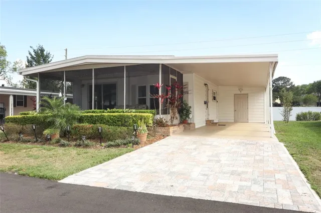 a view of a house with backyard and porch