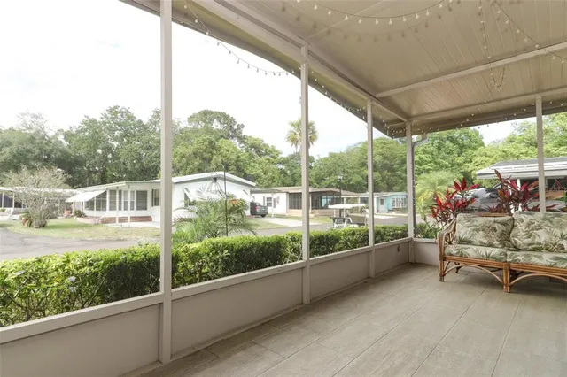 a view of a porch with furniture and in front of the house