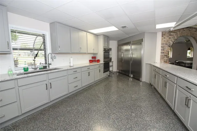 a view of swimming pool with chairs and fire pit