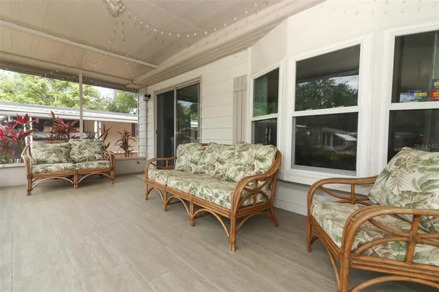 a bedroom with furniture and a large window