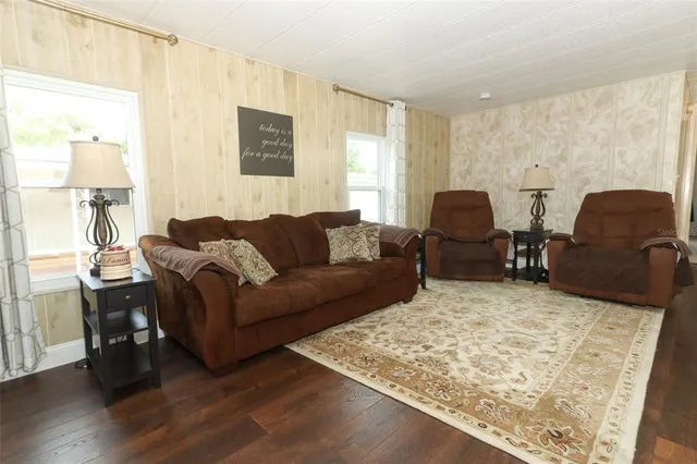 a living room with furniture rug and wooden floor