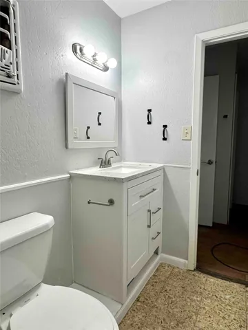 a spacious bathroom with a sink toilet and shower