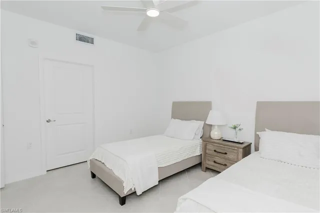 a bedroom with two beds and a couch