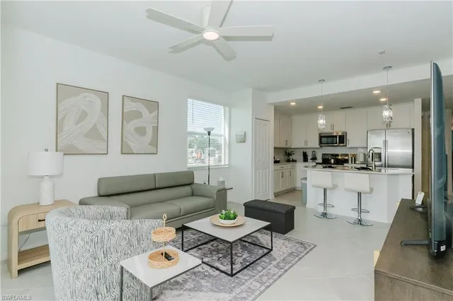 a living room with furniture kitchen view and a dining table