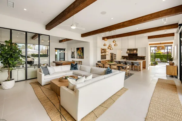 a living room with furniture large window and flat screen tv