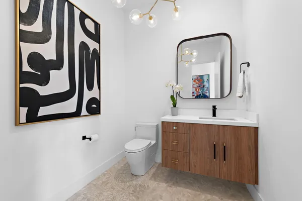 a bathroom with a toilet sink and mirror