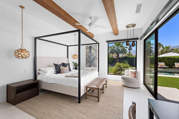 a bedroom with a bed and a potted plant