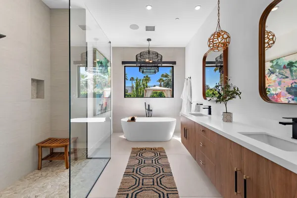 a spacious bathroom with a sink mirror and a bathtub