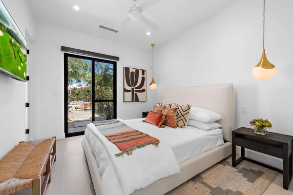 a bedroom with a bed and a chandelier