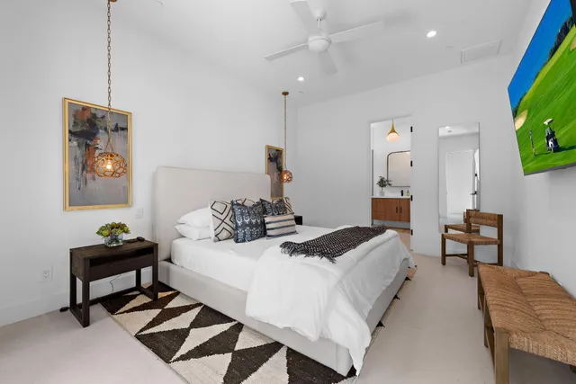 a bedroom with a bed and a chandelier