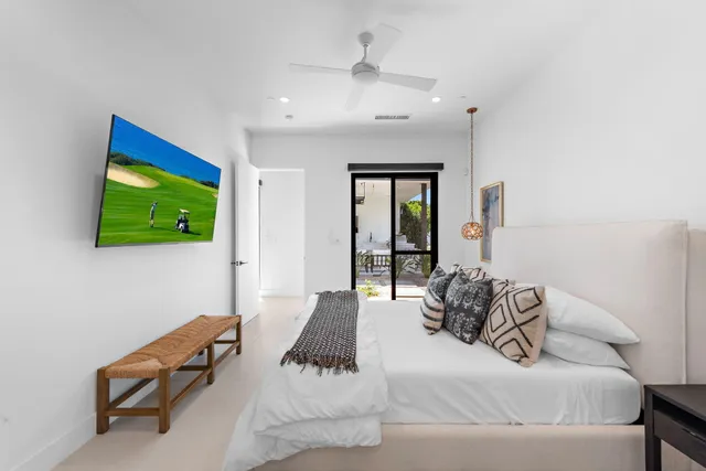 a bedroom with a bed and a flat screen tv