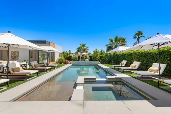 a view of swimming pool with lounge chair
