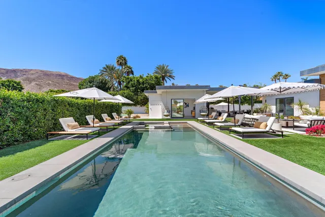 a view of a house with swimming pool yard and outdoor seating