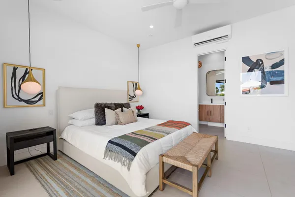 a bedroom with a bed and a chandelier