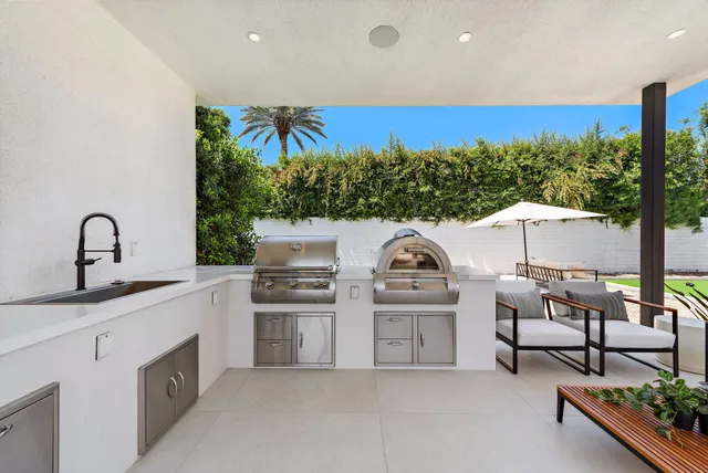 a kitchen with stainless steel appliances granite countertop a stove and a sink