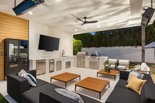 a living room with furniture a flat screen tv and a window